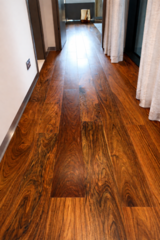 Drewniana podłoga amazouke w korytarzu z widokiem na drzwi i detale wykończenia